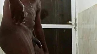 horny guy strokes huge black cock in steamy shower solo