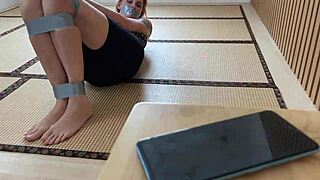 Duct-Taped Redhead Girlfriend Displays Cute Feet in Bondage