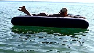 Who's that big-titted blonde flashing her pussy on the nude beach?