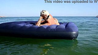 Who's that big-titted blonde flashing her pussy on the nude beach?