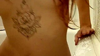that redhead teen slips into a steamy bath showing off her tattooed skin