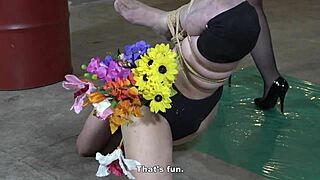 Asian Femdom Mistress Crams Flowers in Slave's Anal Vase