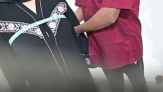 Tailor using hijab lady while taking measurement of blouse