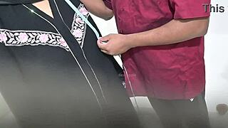 Tailor using hijab lady while taking measurement of blouse
