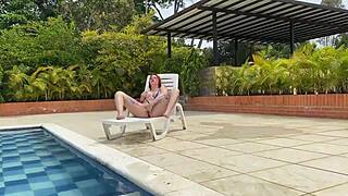 Naughty redhead tastes big cock in pool
